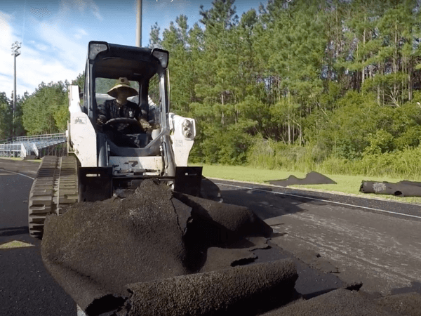 A bulldozer is working on a road.
