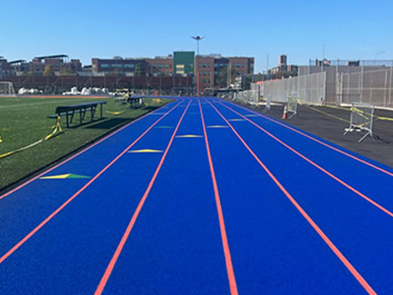 A blue track with yellow lines on it.